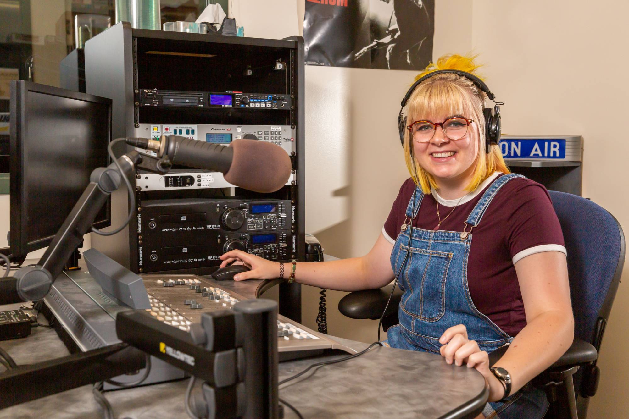 GV student wearing headphones sits in the Whale Radio studio